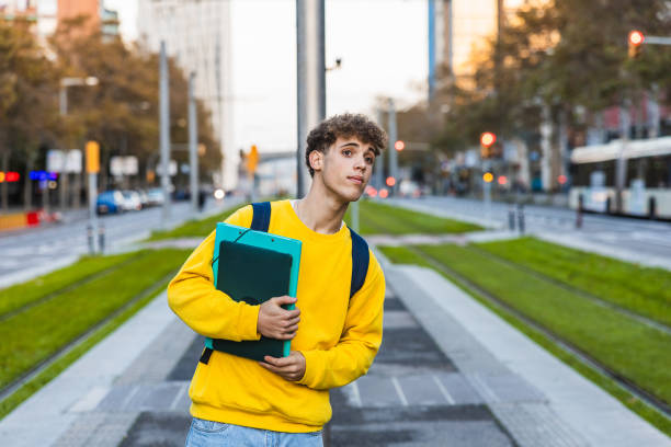 istock Young college student waiting at tram stop in city 2194356388