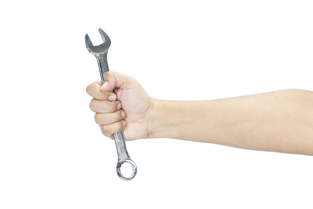 istock Man's hand holds a wrench isolated on white background with clipping path. 2194363099