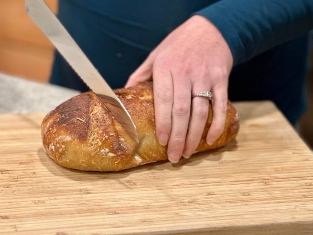 istock Baked Sourdough Loaf Being Cut 2194364190