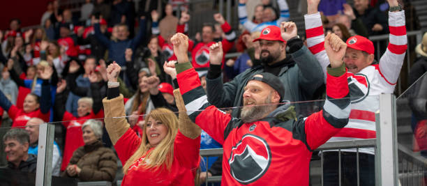 istock Ice Hockey Game: Enthusiastic Hockey Fans in Vibrant Red Jerseys 2194365565
