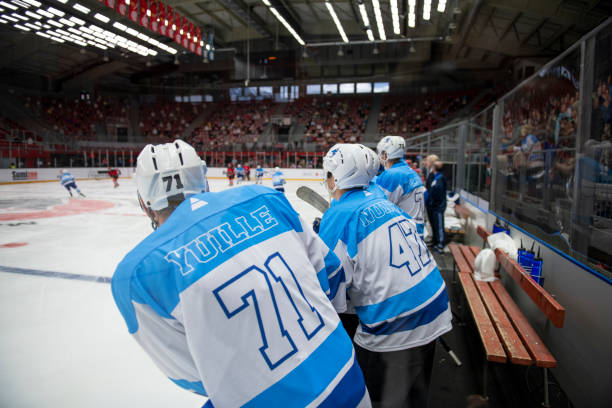 istock Ice Hockey Players Watching the Game on the Bench 2194367496