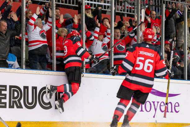 istock Ice Hockey Player Celebrates Goal with Enthusiastic Fans 2194367996