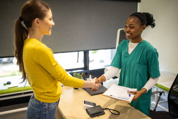 istock Female doctor shaking hands with a patient 2194368124