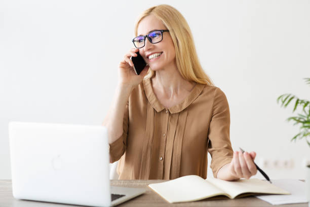 istock Mature Entrepreneur Having Phone Talk And Taking Notes 2194368838
