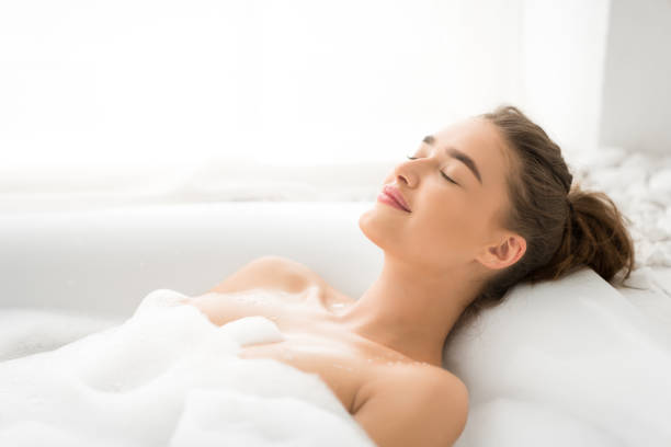 istock Relaxed woman enjoying hot bath with foam 2194369193