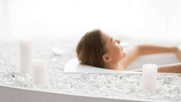 istock Total relaxation. Woman enjoying hot bath with candles 2194369196