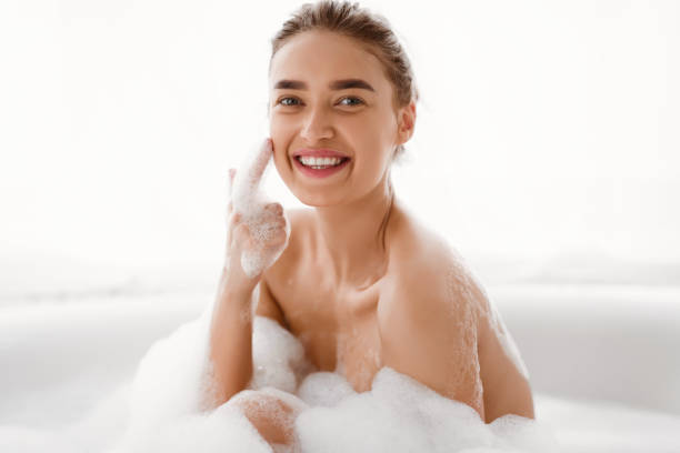 istock Enjoying Bubble Bath. Playful Woman Looking At Camera 2194369296
