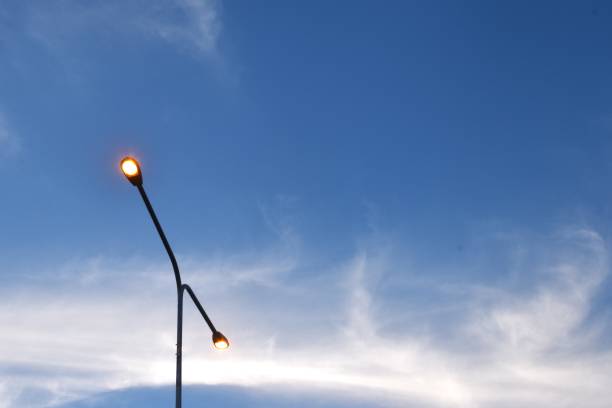 istock electric lamp pole on cloud and sky background 2194370248