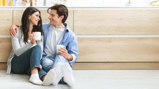 istock Couple Enjoying a Cozy Morning Together With Coffee in a Bright Kitchen Setting 2194370310