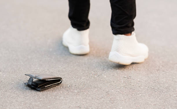 istock Man accidently dropped his leather wallet with money 2194372056