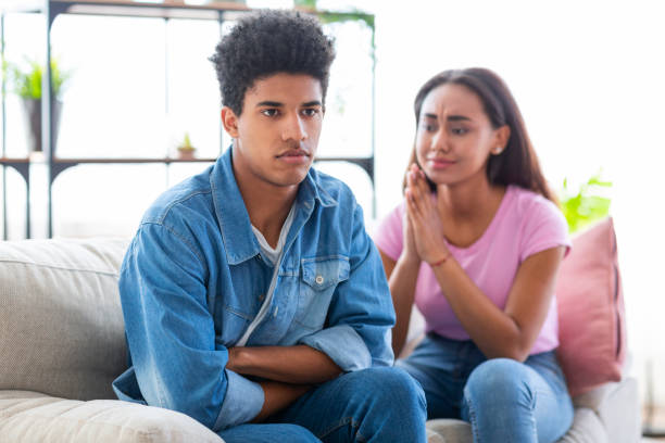 istock Young Couple Sitting on a Couch Experiencing Tension During a Conversation in a Bright Room 2194372545