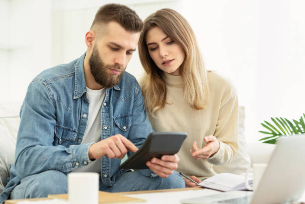 istock Couple Discussing Plans While Looking at Tablet in Modern Living Room 2194372785