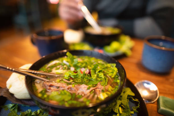 istock Man eating Vietnamese dish Pho soup in a cafe 2194372923