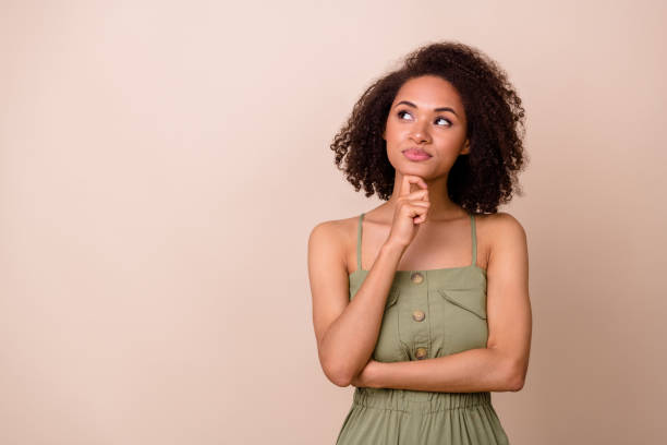istock Photo of clever dreamy lady arm touch face has question doubt idea unsure look empty space isolated on beige color background 2194373956