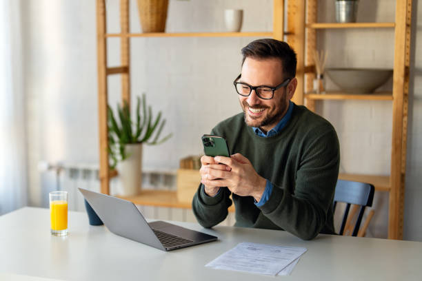 istock Man using smartphone and laptop computer for electronic banking, making reservation, online shopping 2194375601