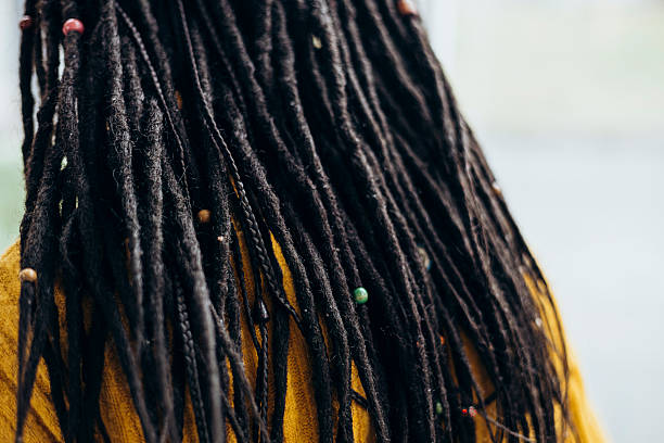 istock Back view of a woman's hairstyle with dreadlocks, close-up. 2194376361
