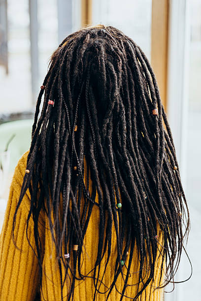 istock Back view of a woman's hairstyle with dreadlocks, close-up. 2194376364