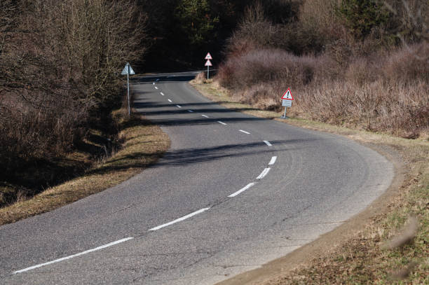 istock Winding Rural Road with Traffic Signs 2194377024