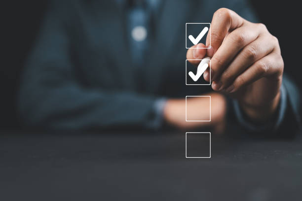 istock Businessman use pen to tick correct sign mark in checkbox for quality document control checklist and business approve project concept. 2194377815