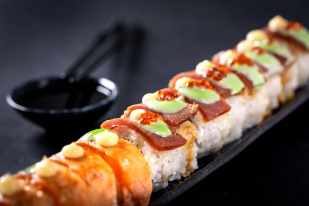 istock Japanese cuisine. Sushi rolls on a black platter 2194379291