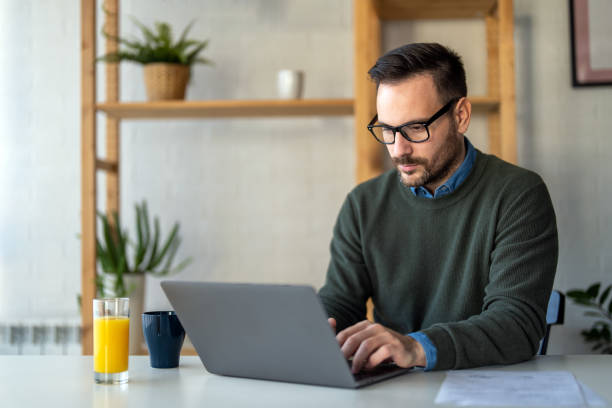 istock Success man typing on laptop, communicating online distantly working or studying on computer at home 2194381823