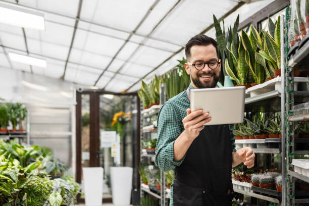 istock Focused Florist Managing Plant Inventory with Digital Tablet 2194381918