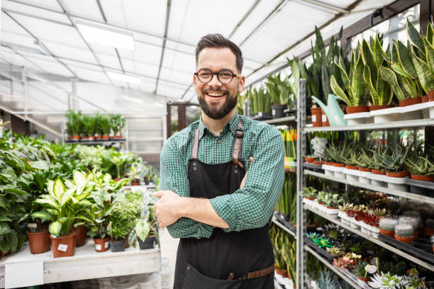 istock Confident Florist Standing Among Potted Plants 2194381944
