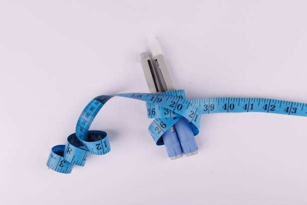 istock Semaglutide medication pens tied with a blue measuring tape on a white surface 2194382453