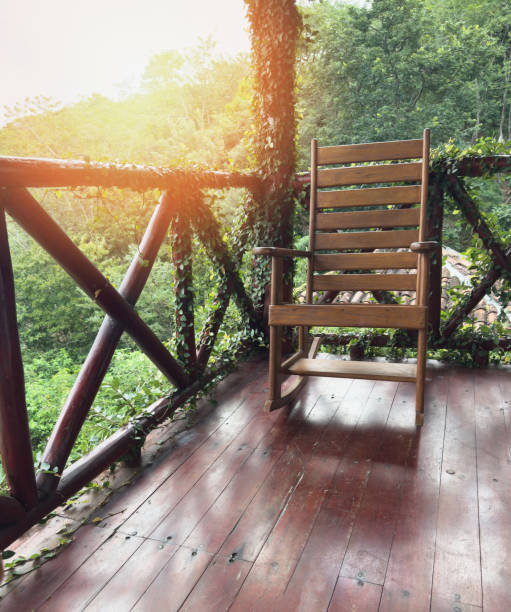 istock Relaxing chair on balcony overlooking lush greenery during golden hour 2194383044