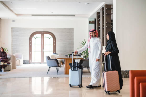 istock Smiling Arabic Couple Arriving in Modern Hotel Lobby 2194383713