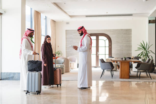 istock Friendly Hotel Manager Welcoming Arabic Couple in Modern Lobby 2194383761