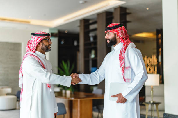 istock Arabic Businessmen Shaking Hands in Modern Hotel Lobby 2194383809