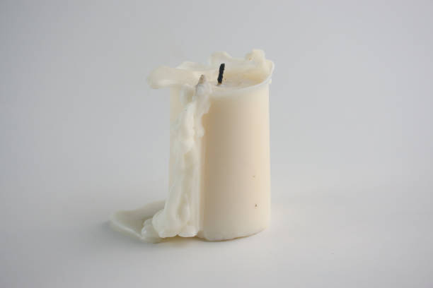 istock Melted White Candle Symbolizing Time and Serenity on Simple Surface 2194385555
