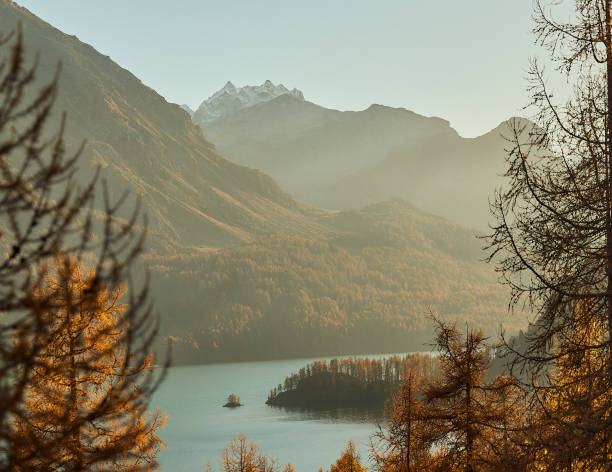 istock View through the trees. Mountain lake, turquoise water. Golden fall trees with mountain. 2194385740