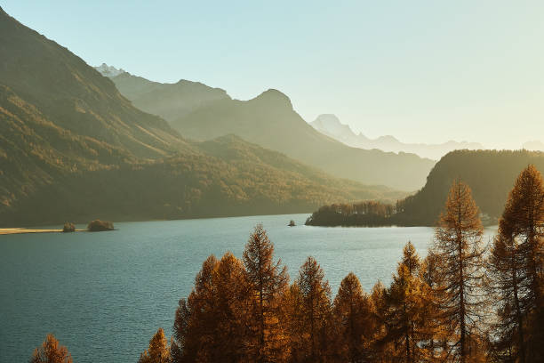 istock Large mountain lake, turquoise water. Golden fall trees with mountain. 2194385762