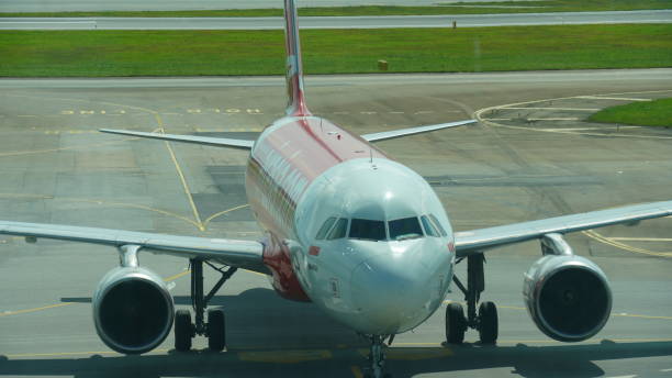 Singapore, December 29 ,2024The AirAsia aircraft at Terminal 4, Singapore Changi Airport, highlights seamless travel in a state-of-the-art passenger terminal.