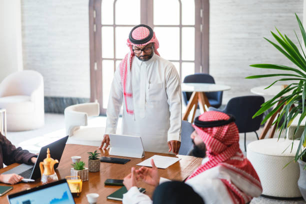 istock Professional Arabic Business Executives Collaborating in Modern Hotel Lobby 2194386239