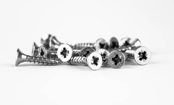 istock A collection of metal screws scattered on a white background 2194386471