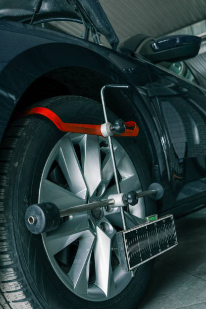 istock Close-up of a car wheel being measured for alignment using professional calibration equipment in an auto workshop 2194386765