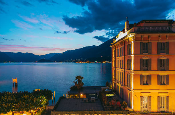 Lake Como and Bellagio glowing during blue hour with mountains and beautiful historic buildings in the foreground, creating a magical atmosphere