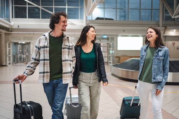 istock Family walking through airport terminal pulling suitcases 2194387785