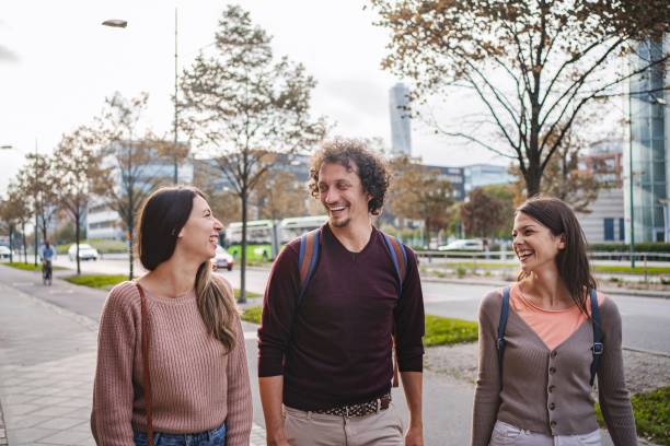 istock Three young adults walking and talking in malmo, sweden 2194388818