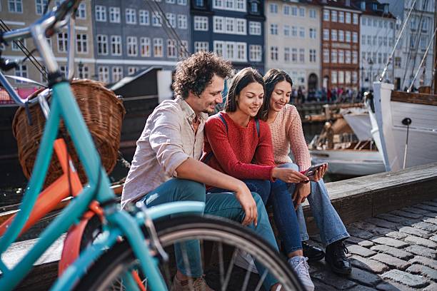 istock Tourists using a smartphone in nyhavn, copenhagen, denmark 2194389237