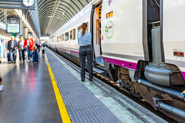 Seville Santa Justa Train Station, Spain The train parked at the platform is waiting for tourists boarding. Seville Santa Justa Train Station view, Spain. santa justa lift portugal stock pictures, royalty-free photos & images