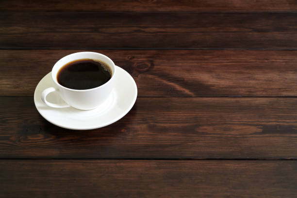 istock Porcelain Coffee Cup with Black Coffee on Rustic Wooden Table 2194391275