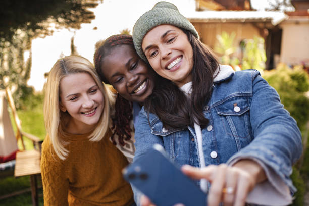 istock Three happy female friends taking a selfie in the backyard 2194391318