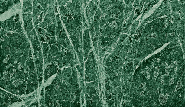 istock Real closeup of dark green marble stone texture surface background. Design pattern with high resolution for luxury home decoration. Abstract matt slab rock material. Front view of natural tiles stone surface. 2194391726