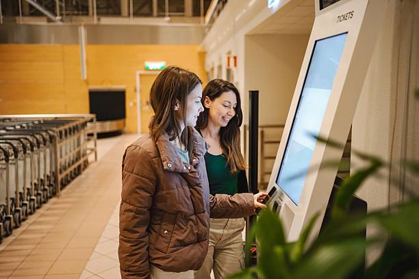 istock Passengers using self-service check-in kiosk at airport 2194391781