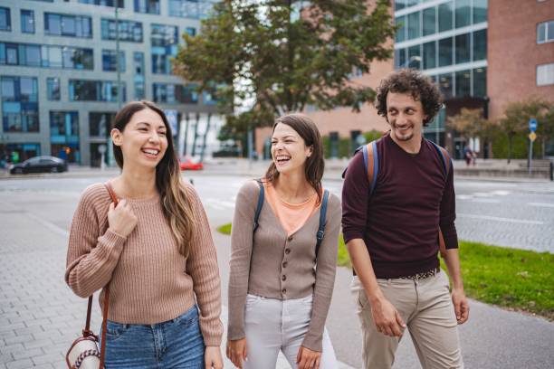istock Three young adults walking and laughing in malmo city center 2194391921