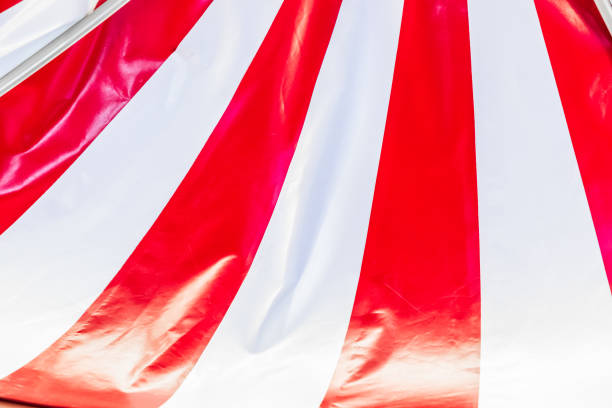 istock Circus tent background. Colorful design, striped white and red, retro style. 2194391995